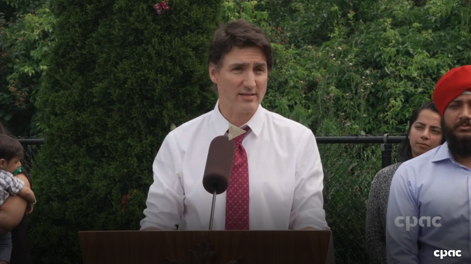 A screenshot from the CPAC video of Justin Trudeau making an announcement at a lectern.