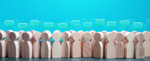 Little wooden human figures with speech bubbles over their heads on a blue-green background.