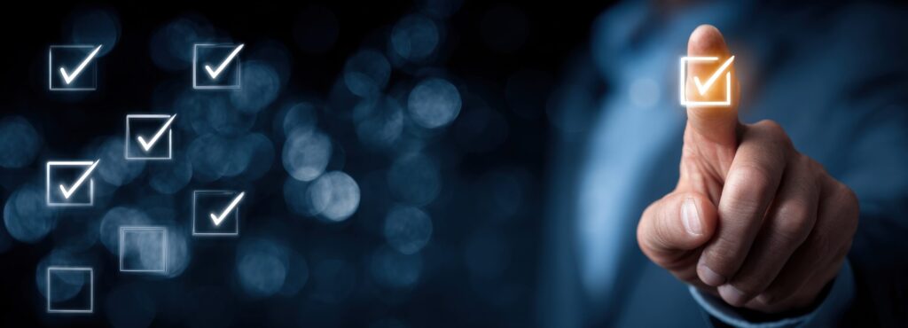 A hand touches a glowing checkmark, with more checkmarks displayed over a blurred bokeh background in shades of blue